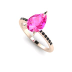 Front three-quarter studio view of the Calista pink sapphire ring, highlighting the row of black pavé diamonds set beautifully into the warm rose gold shoulders.