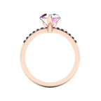 Through-finger view of the 18ct rose gold pink sapphire ring, showing the smooth interior under-gallery and precise stone settings.