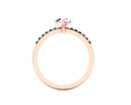 Through-finger view of the 18ct rose gold sapphire ring, showing the clean interior under-gallery and precise settings for the accent black diamonds.