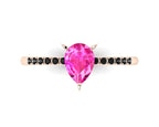 Top-down studio hero shot of the Calista ring, featuring a vibrant pear-shaped pink sapphire on an 18ct rose gold band with black diamond shoulders.