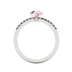 Through-finger view of the white gold or platinum sapphire ring, showing the clean interior under-gallery and precise settings for the accent black diamonds.