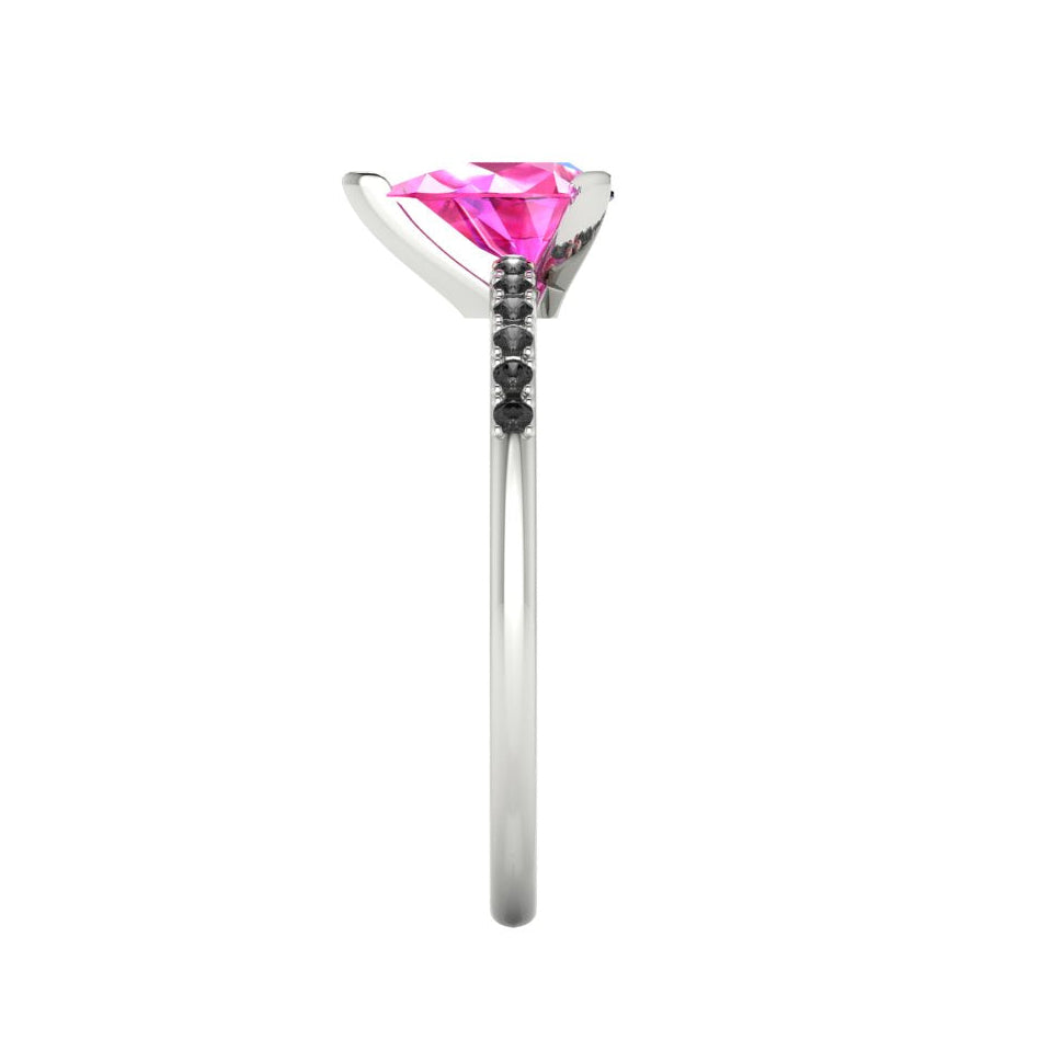 Side profile product photo of the Calista ring, displaying the elegant three-prong basket setting holding the pear-cut pink sapphire.