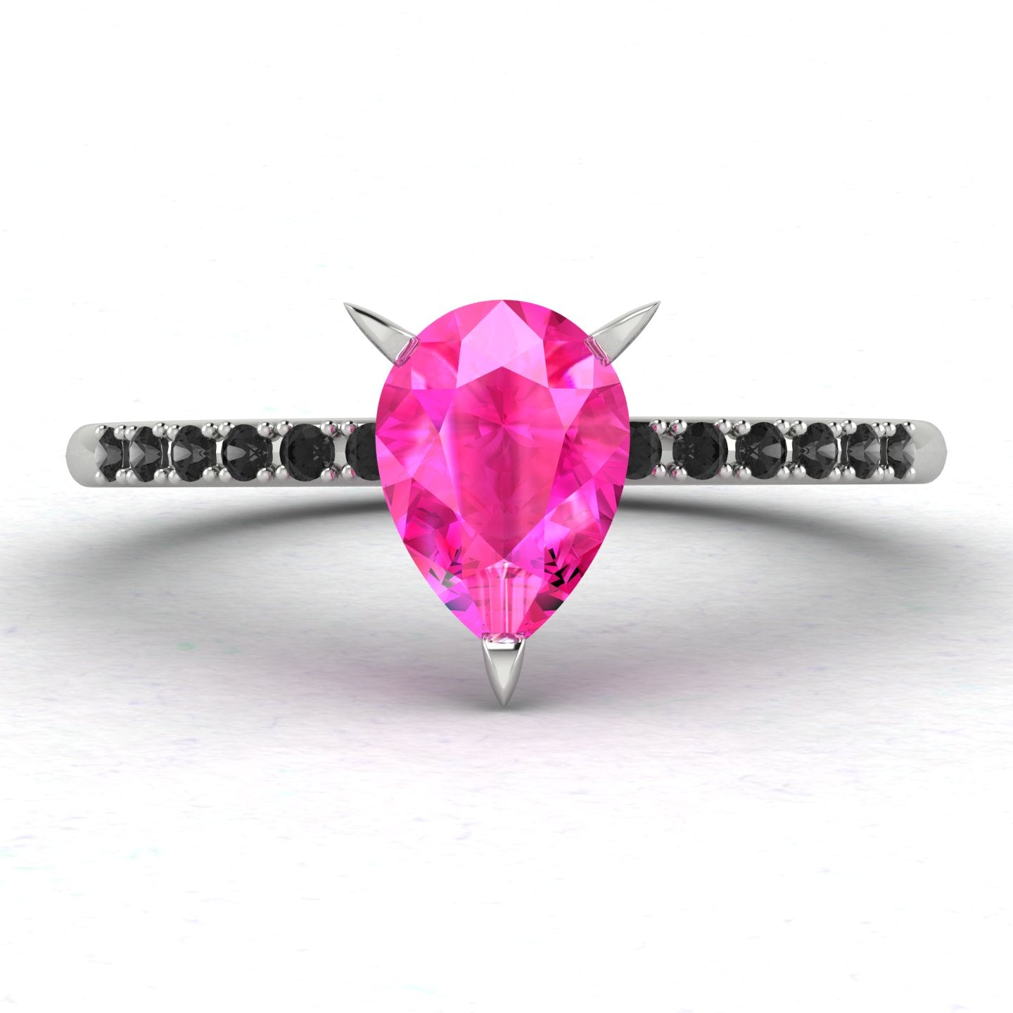 High angle studio detail shot of the Calista alternative engagement ring, showing the bright pink clarity of the sapphire facets against the dark shoulder stones.