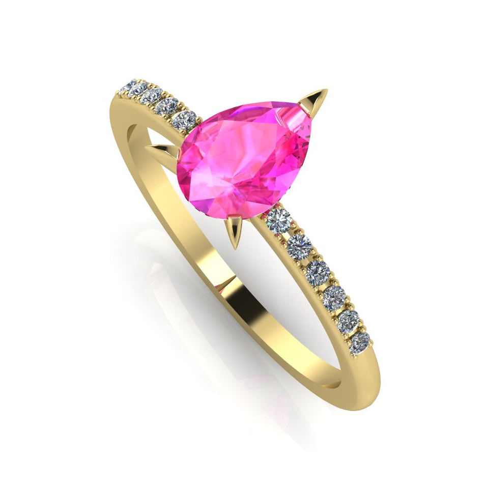 Front three-quarter studio view of the Calista pink sapphire ring, highlighting the beautiful contrast of the brilliant white diamonds set into the warm yellow gold shoulders.