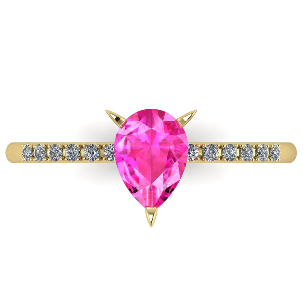 High angle studio detail shot of the Calista alternative engagement ring, showing the rich pink clarity and facet reflections within the sapphire centre stone.