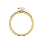Through-finger view of the 18ct yellow gold sapphire ring, showing the height of the pink sapphire setting.