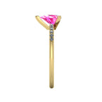 Side profile product photo of the Calista ring, displaying the elegant three-prong claw basket setting holding the pear-cut pink sapphire.