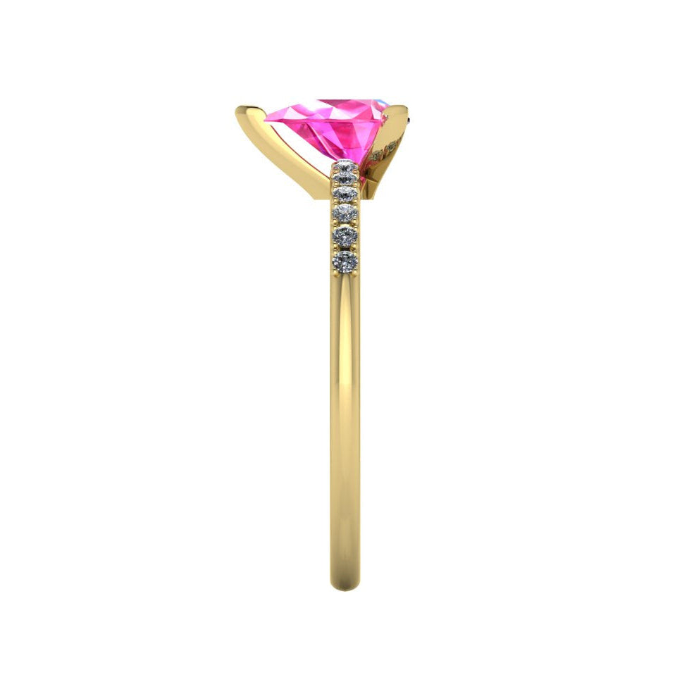 Side profile product photo of the Calista ring, displaying the elegant three-prong claw basket setting holding the pear-cut pink sapphire.