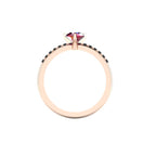 Through-finger view of the 18ct rose gold ruby ring, showing the clean interior under-gallery and precise settings for the accent black diamonds.