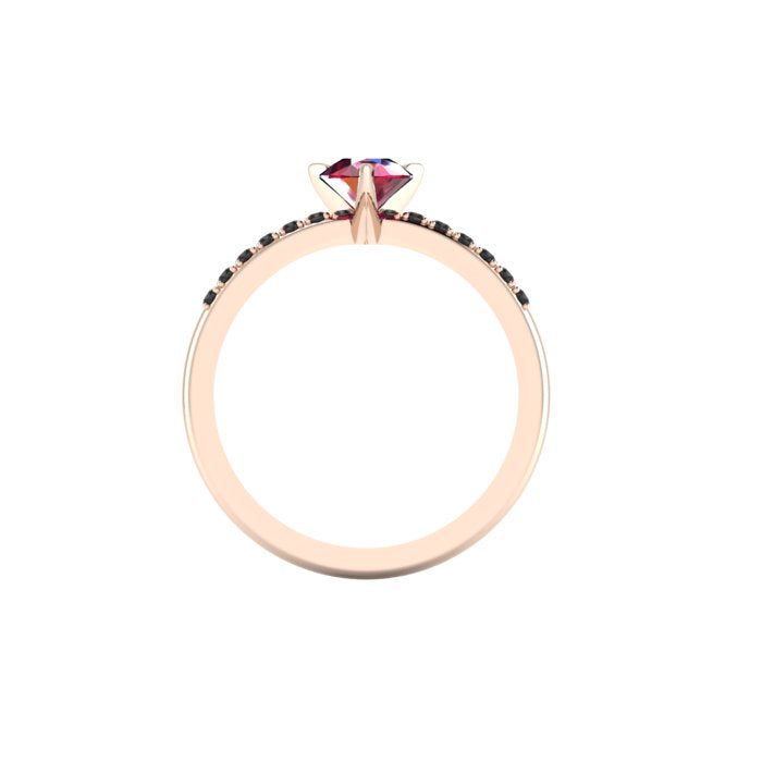 Through-finger view of the 18ct rose gold ruby ring, showing the clean interior under-gallery and precise settings for the accent black diamonds.