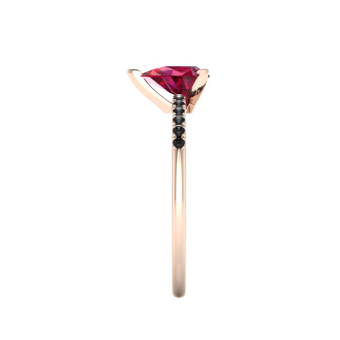 Side profile product photo of the Calista ring, displaying the clean, delicate three-prong basket setting holding the 7x5mm pear ruby.
