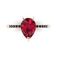 Top-down studio hero shot of the Calista engagement ring, featuring a 2-carat pear-shaped red ruby on a rose gold band set with black diamonds.