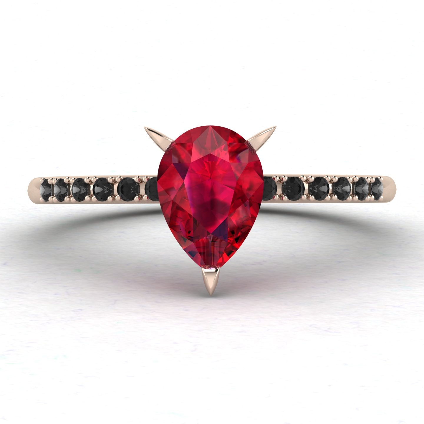 Front studio hero shot of the Calista engagement ring, featuring a 0.69ct pear-shaped red ruby on a thin recycled rose gold band with black diamonds.