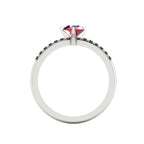 Through-finger view of the white gold or platinum ruby ring, showing the clean interior under-gallery and precise settings for the accent black diamonds.