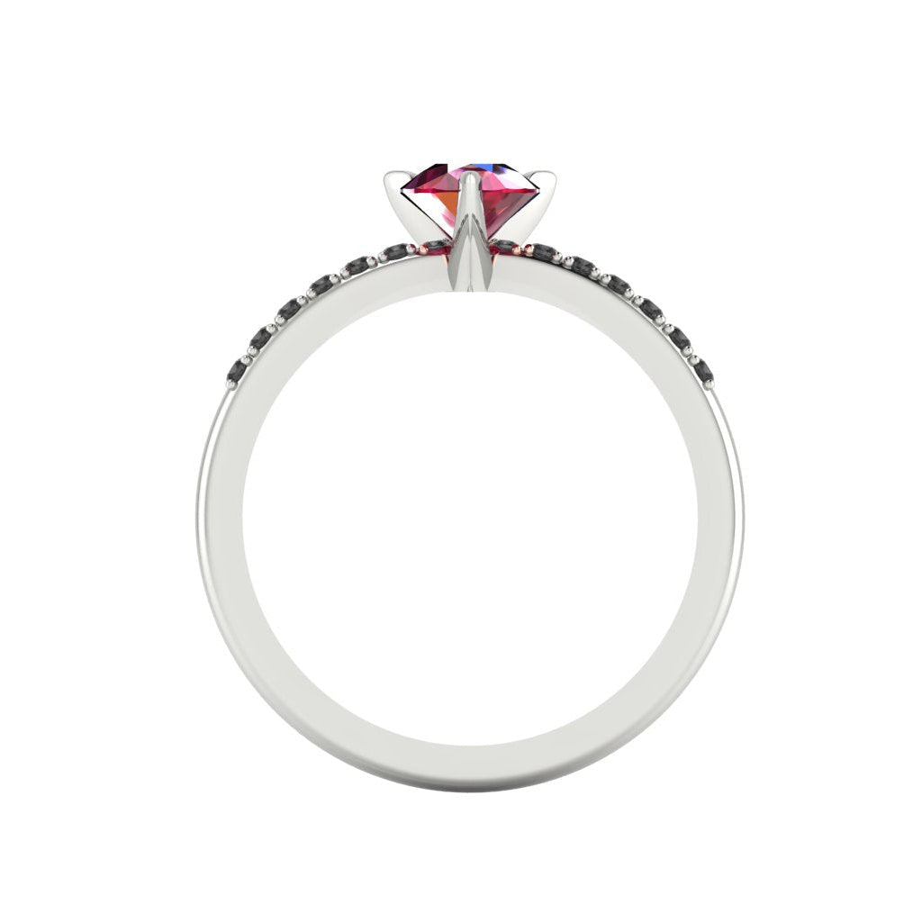 Through-finger view of the white gold or platinum ruby ring, showing the clean interior under-gallery and precise settings for the accent black diamonds.