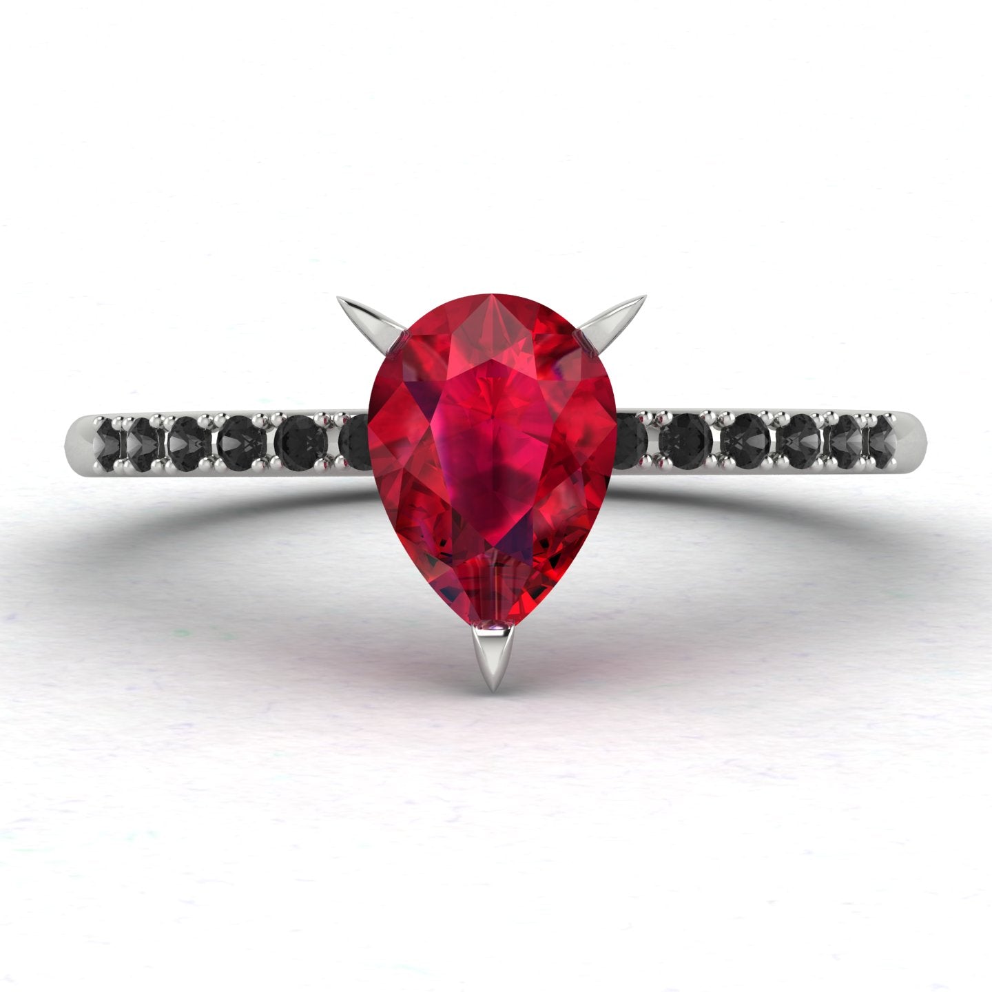 Front studio view of the Calista ruby ring, showcasing the striking contrast of the black diamonds set into the polished white metal shoulders.