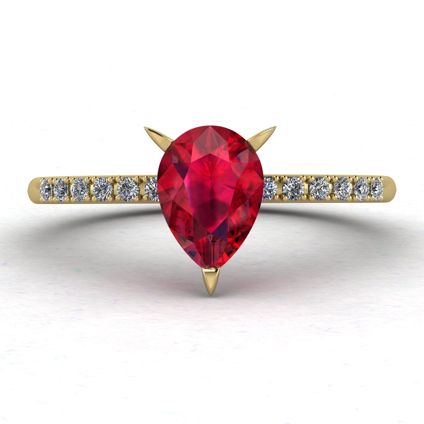 Front view of the Calista engagement ring, showcasing a vibrant pear-shaped red ruby on a polished yellow gold band with diamond shoulders.