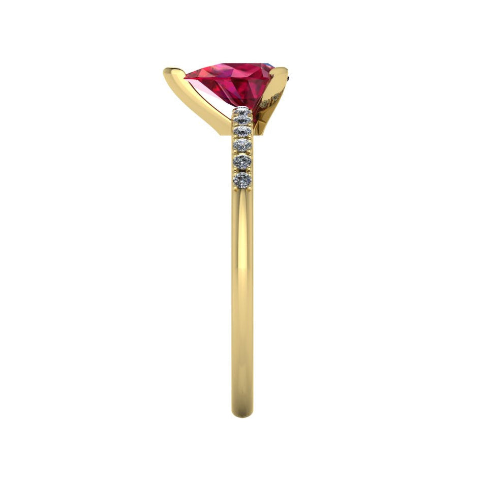 Side profile product photo of the Calista ring, displaying the clean, secure three-prong claw basket setting holding the pear-cut ruby.