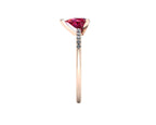 Side profile product photo of the Calista ring, displaying the clean, secure three-prong claw basket setting holding the pear-cut ruby.