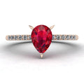 Calista ruby ring in 18ct rose gold, capturing the rich, fiery crimson shimmer of the pear centre stone and brilliant white diamond shoulders.