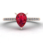 Calista ruby ring in 18ct rose gold, capturing the rich, fiery crimson shimmer of the pear centre stone and brilliant white diamond shoulders.