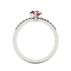 Through-finger view of the white gold or platinum ruby ring, showing the clean interior under-gallery and precise craftsmanship of the diamond settings.