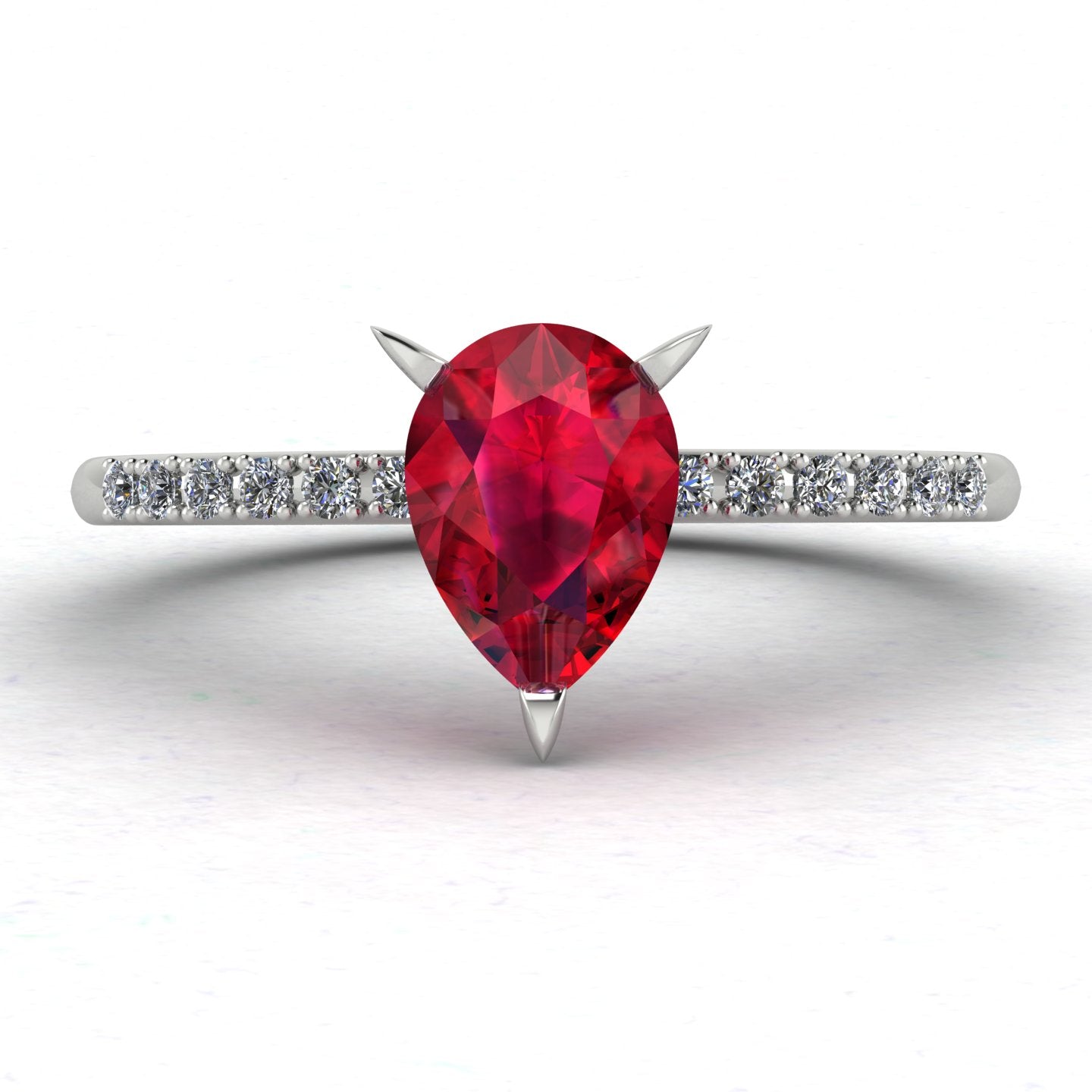 Top-down studio hero shot of the Calista engagement ring, showcasing a vibrant pear-shaped red ruby on a white gold or platinum band with diamond shoulders.