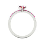Through-finger view of the white gold or platinum ring, showing the clean interior under-gallery and precise craftsmanship of the pink sapphire settings.