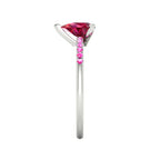 Side profile product photo of the Calista ring, displaying the sleek, secure three-prong basket setting holding the pear-cut ruby.