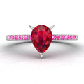 Calista engagement ring, showcasing a prominent pear-shaped red ruby on a white gold or platinum band with vibrant pink sapphire shoulders.