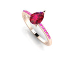 Front three-quarter studio view of the Calista ruby ring, highlighting the beautiful tonal gradient of the pink sapphires set directly into the warm rose gold shoulders.
