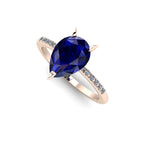 Front three-quarter studio view of the Calista sapphire ring, highlighting the row of brilliant white pavé diamonds set beautifully into the warm rose gold shoulders.