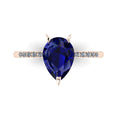 Top image of the Calista engagement ring, featuring a magnificent 2-carat pear-shaped blue sapphire on an 18ct rose gold band with sparkling diamond shoulders.