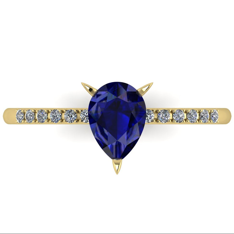 Detail shot of the Calista bridal ring, showing the rich depth of colour and exceptional facet light reflections within the central blue sapphire.