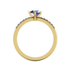 Through-finger view of the 18ct yellow gold sapphire ring, showing the smooth interior under-gallery and precise stone settings.