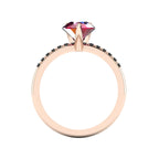 Through-finger view of the 18ct rose gold ruby ring, displaying the clean interior under-gallery and custom black diamond settings.