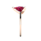 Side profile product photo of the Calista ring, highlighting the elegant three-prong basket setting holding the pear-cut ruby.