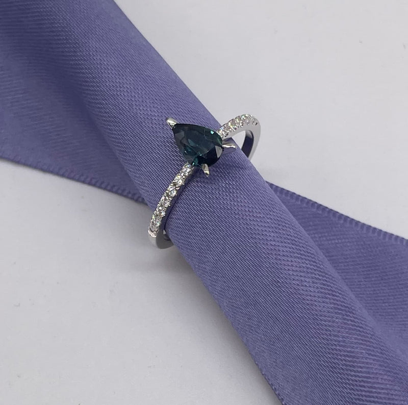Calista engagement ring in 18ct white gold, capturing the cool, icy ocean sparkle of the pear-shaped teal sapphire and brilliant white diamonds.