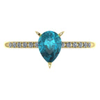 Top view of the Calista 18ct yellow gold ring, featuring a rich pear-shaped teal sapphire surrounded by a halo of white diamonds. 