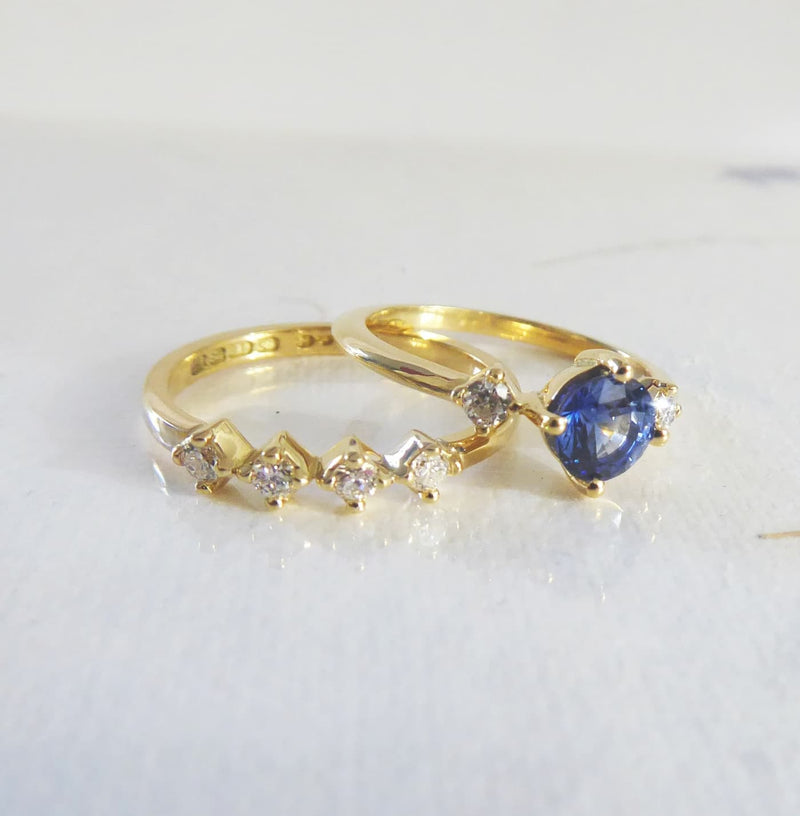 A bespoke set featuring a yellow gold and diamond wedding ring with a matching diamond and sapphire engagement ring.