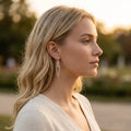 Side profile showing a model wearing the handmade sterling silver Chain Reaction medium earrings to display their scale.