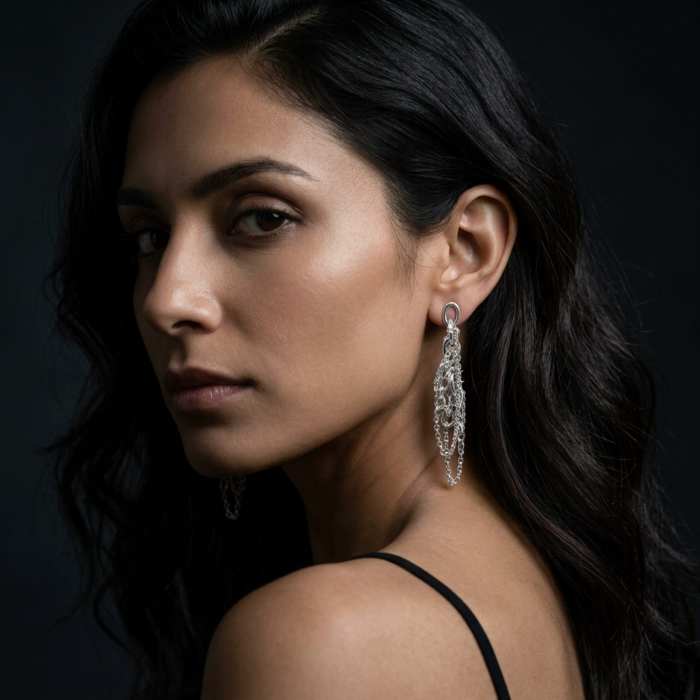 Chain Reaction alternative silver earrings on model, handmade in London