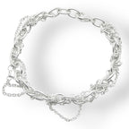 Flat lay view of a heavyweight sterling silver multi-strand bracelet featuring various interconnected chain styles