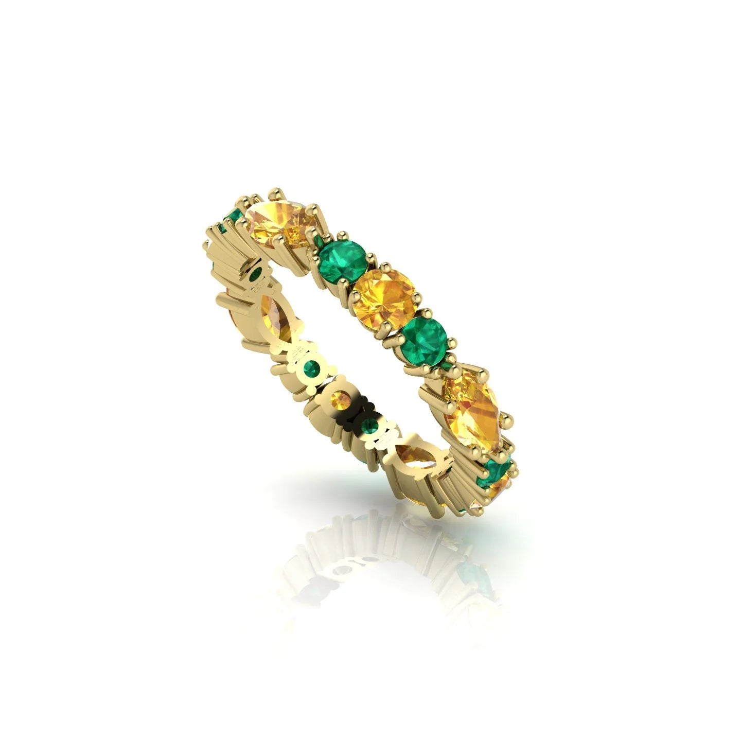 Detailed close-up of the marquise-cut green emeralds and bright yellow sapphires set in a contemporary eternity band.