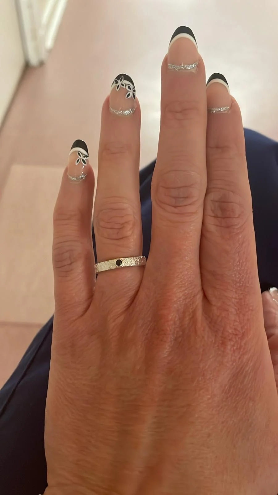 Rivda blue sapphire ring worn on hand showing organic silver texture and sapphire brilliance