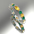 18ct white gold eternity ring featuring alternating marquise yellow sapphires and green emeralds in a claw setting.