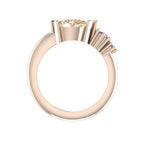 Through-finger view of the Comet rose gold ring, showing the raised champagne diamond setting and stepped settings for two smaller diamonds above the band.