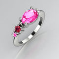 Asymmetrical Comet engagement ring in 18ct white gold with a pear shaped pink sapphire, round ruby and round pink sapphire, handmade in our London studio