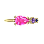 Top view of the Comet yellow gold ring, showing an east-west pear-shaped pink sapphire beside round violet and blue sapphires.