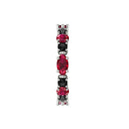 Macro detail showing the contrast between the marquise-cut rubies and the black diamonds in a white gold setting.